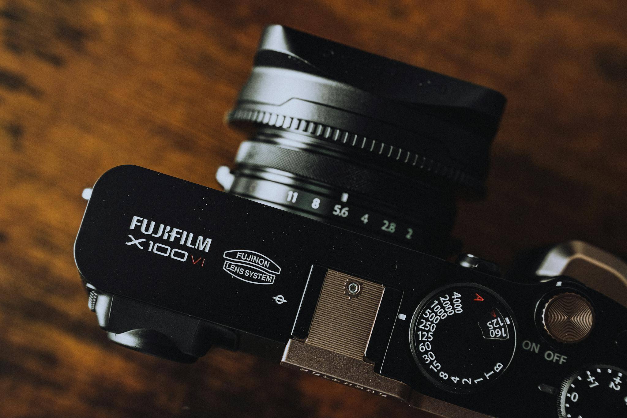 High-quality close-up shot of a Fujifilm X100V camera displaying its controls.